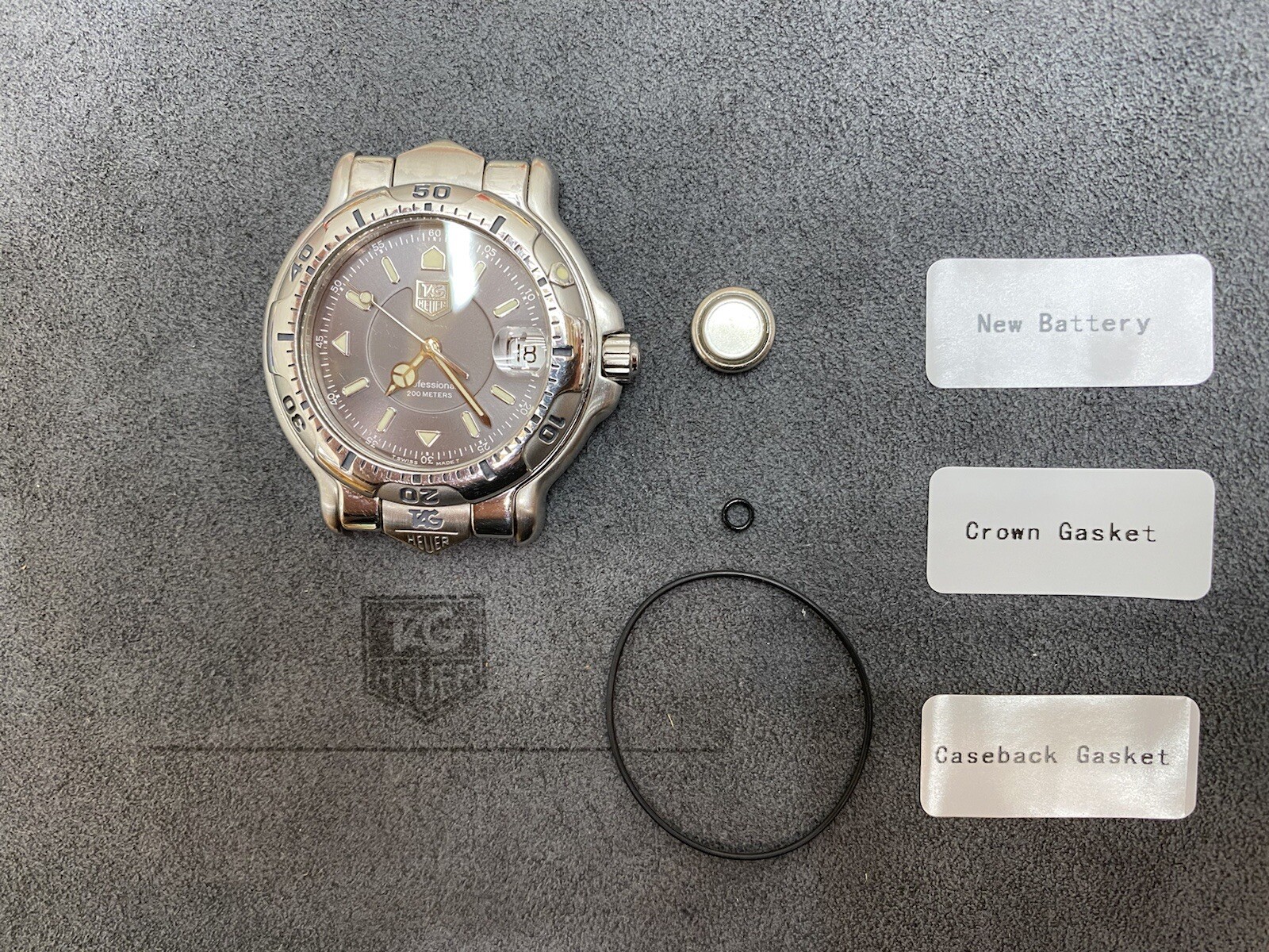 Service Package – Mens Tag Heuer 6000 Series (Crown & Back Gasket Set + Battery)