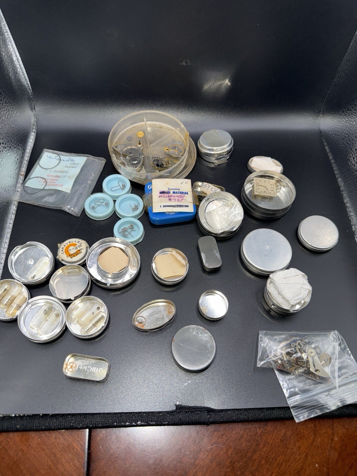 Lot 21 – Watchmaker Parts Lot Movements Staffs Tins Crystals Repair Mixed NOS