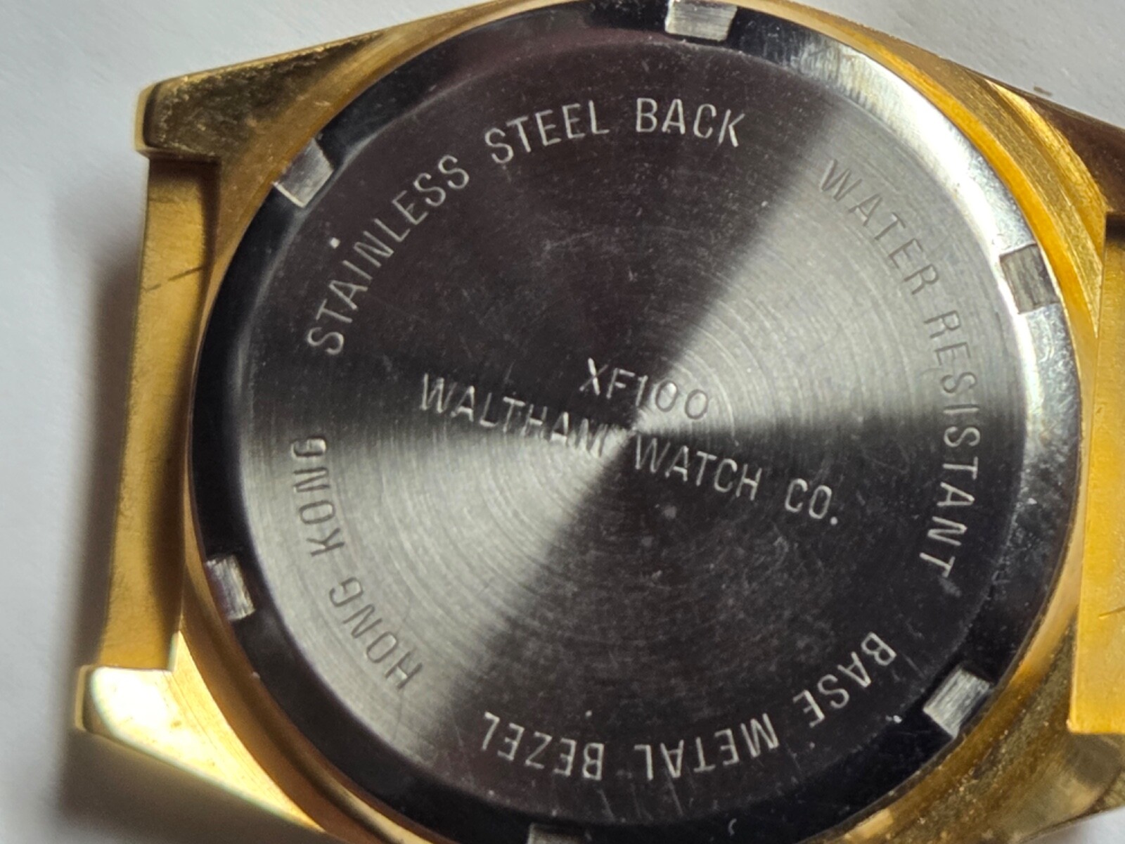 Four (4) men’s watch cases. 1980’s. For quartz movements. One has rotating bezel
