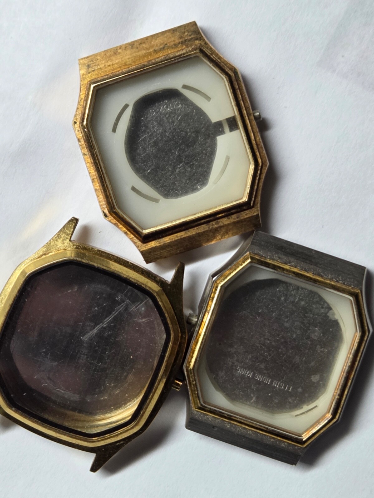 Four (4) men’s watch cases. 1980’s. For quartz movements. One has rotating bezel