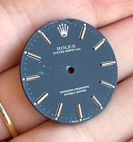 A Genuine Black Rolex Oyster Perpetual Wristwatch Dial.