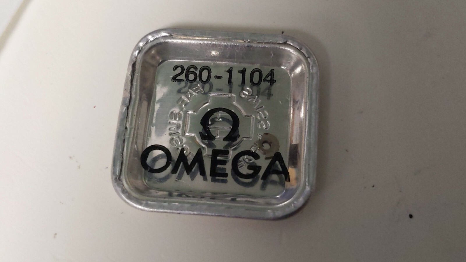 NOS Omega 260 1104 click in pack old maybe some rust – for watch repair