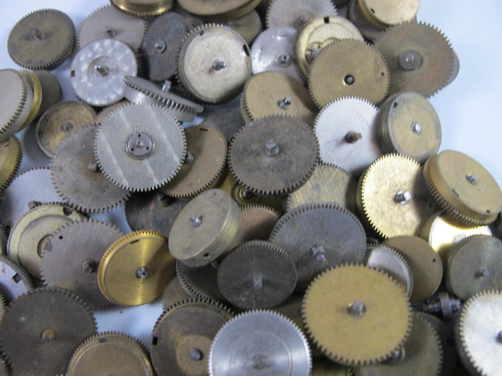 ANTIQUE GROUP OF MAINSPRING BARRELS AND BRIDGES FOR OLD POCKET WATCHES 89 PIECES