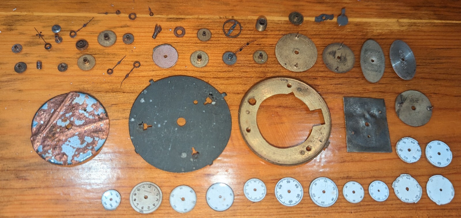 Vintage watch internal parts lot – gears, dials, plates, etc. Sold as is, parts