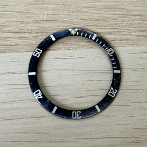 A Genuine Rolex Submariner Wristwatch Bezel Insert. Circa 1980’s