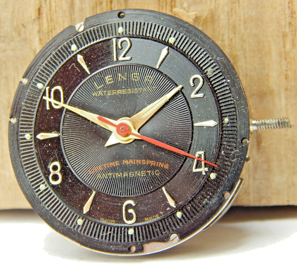 Vintage Fewa QL Lengr men’s wrist watch movement with black dial hands and stem