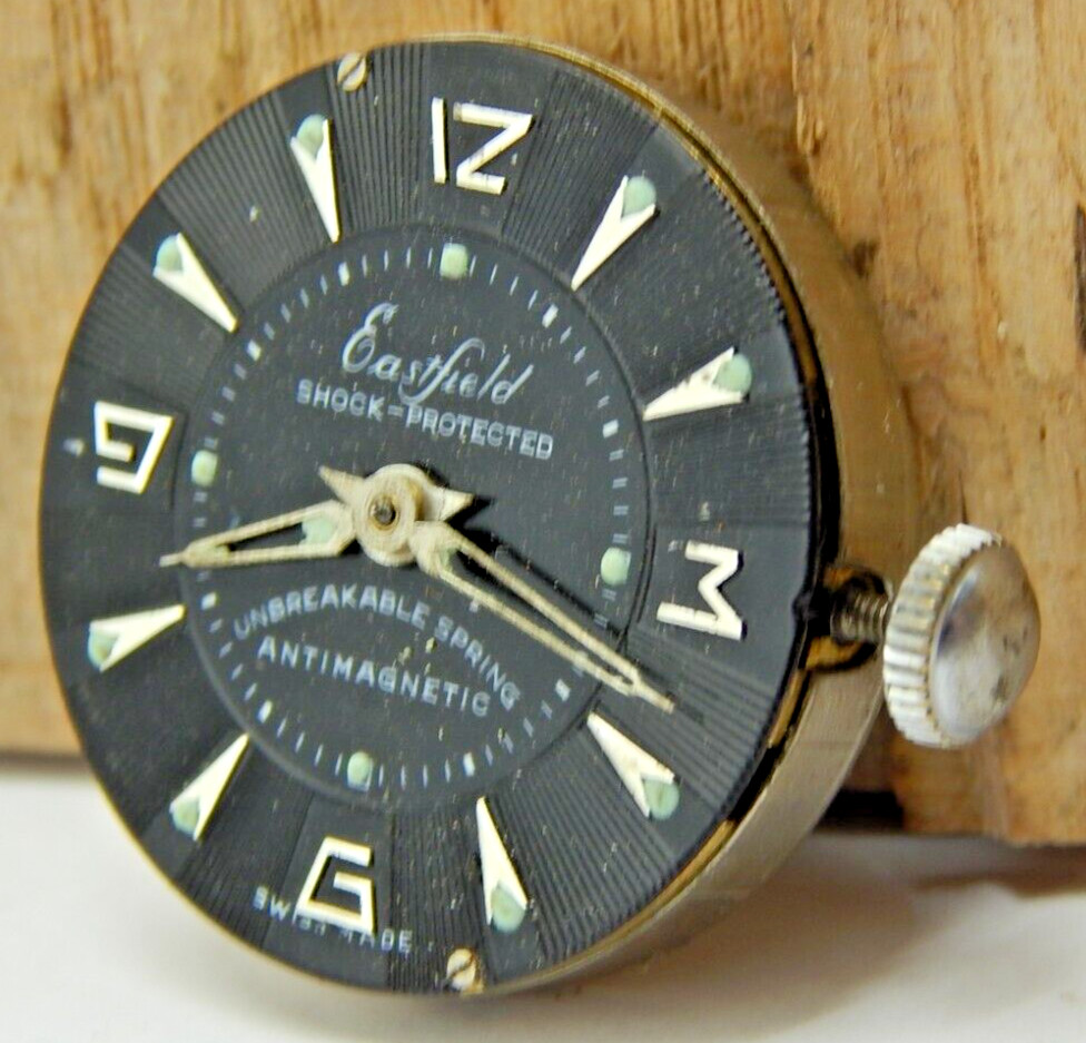 Vintage Eastern men’s wrist watch movement with black dial hands and crown combo