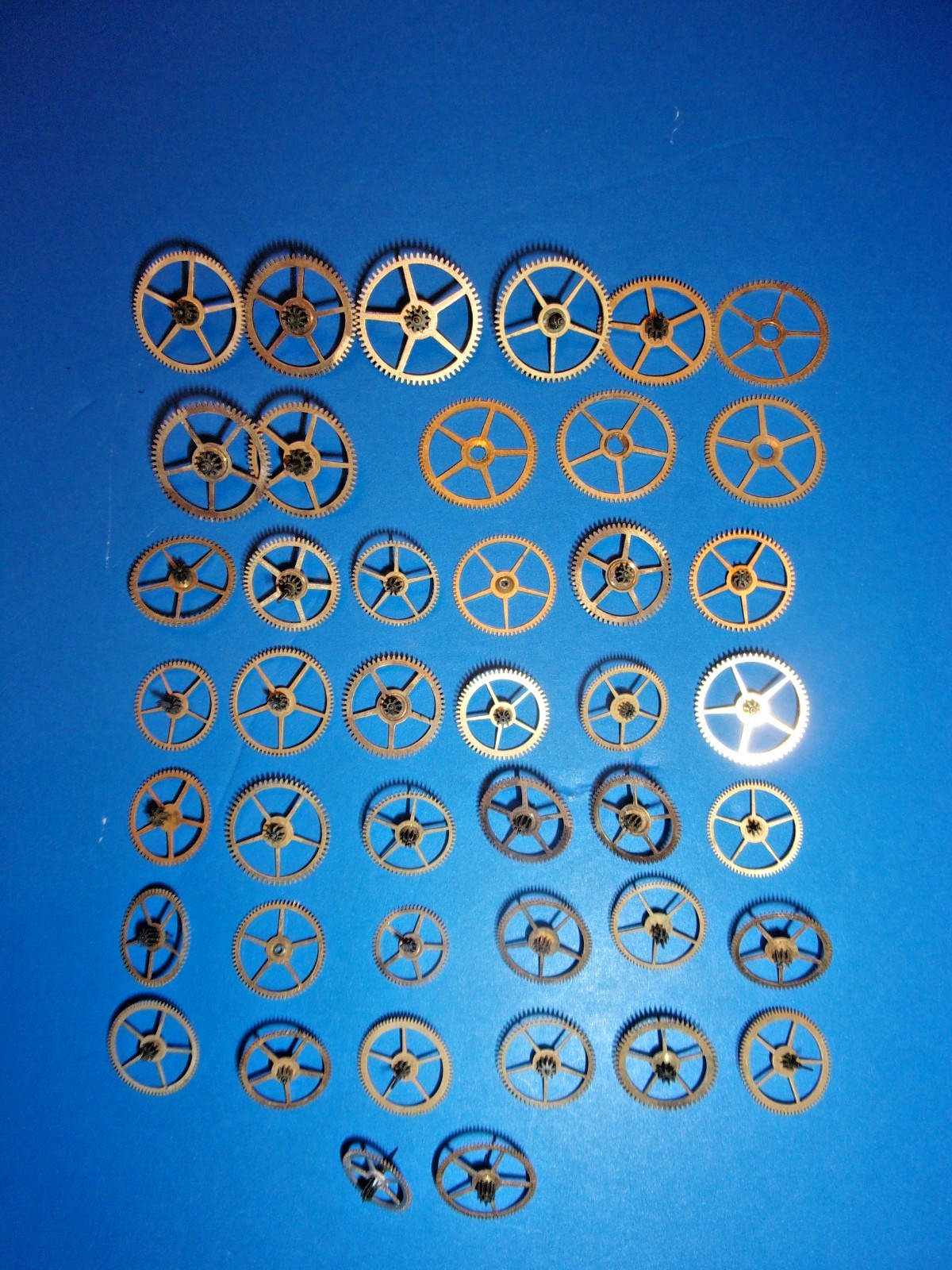 Elgin Pocket Watch Parts, Mix of 3rd and 4th and other power Train Gears + Tin