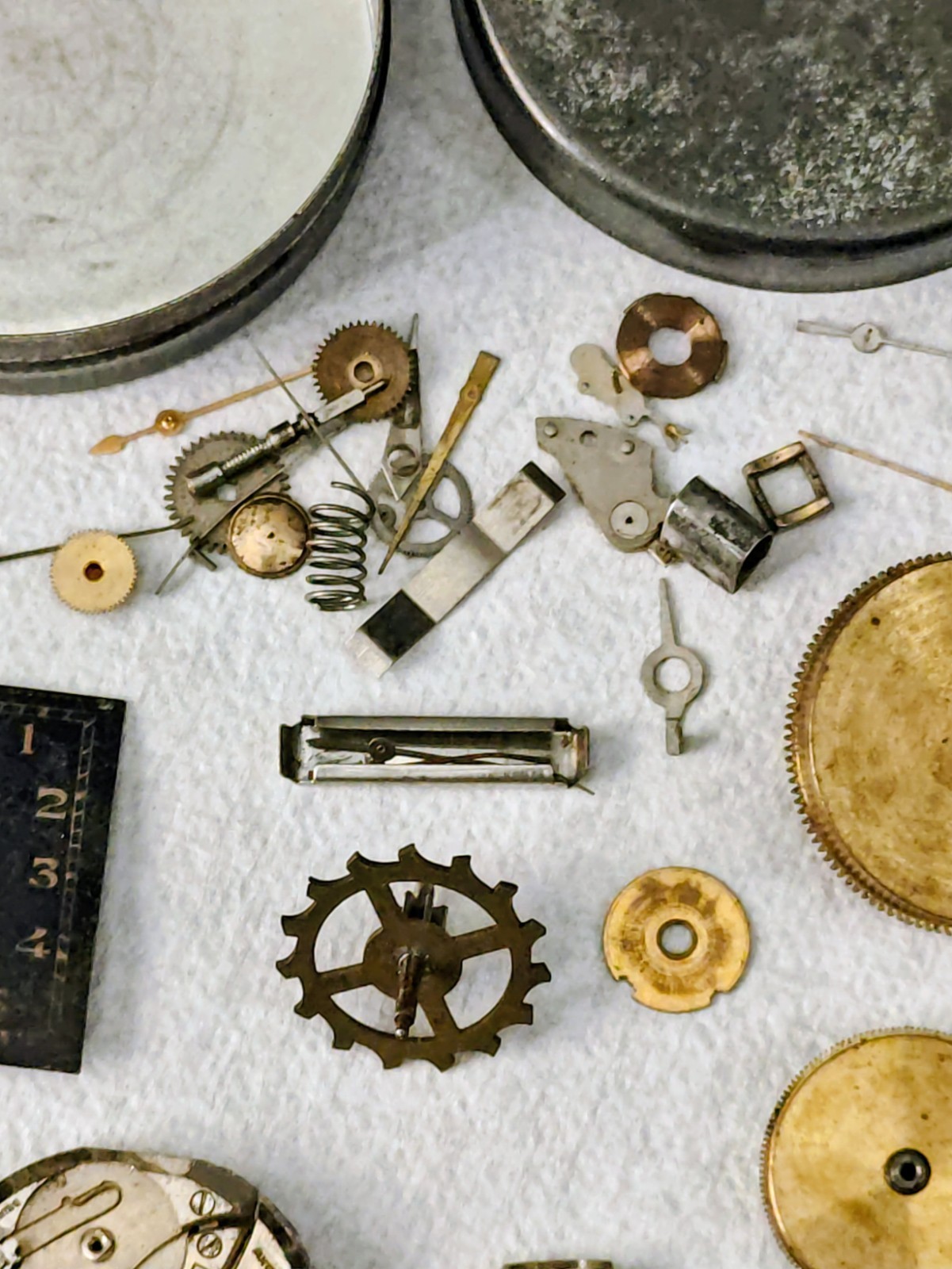 Vintage Watch Parts Including Bulova In A Small Metal Tin Can Approx 13 X 38mm