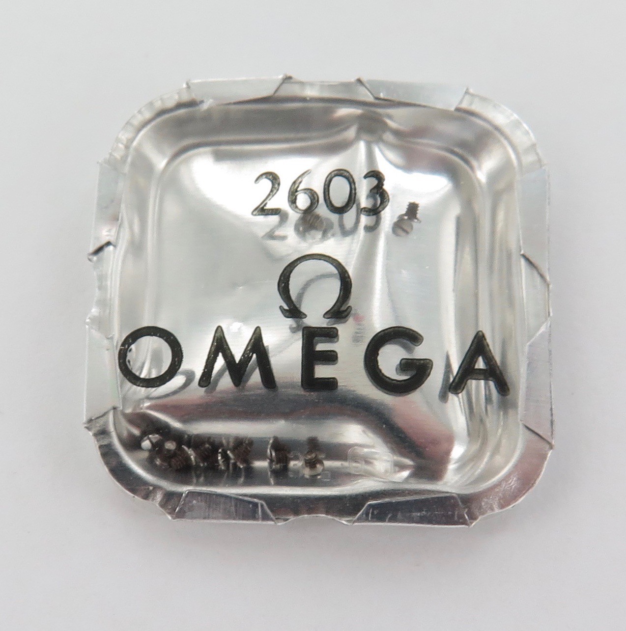 .VINTAGE OMEGA WATCH PART #REF. 2603 PKT 10 SCREWS. NOS IN ORIGINAL PACK.