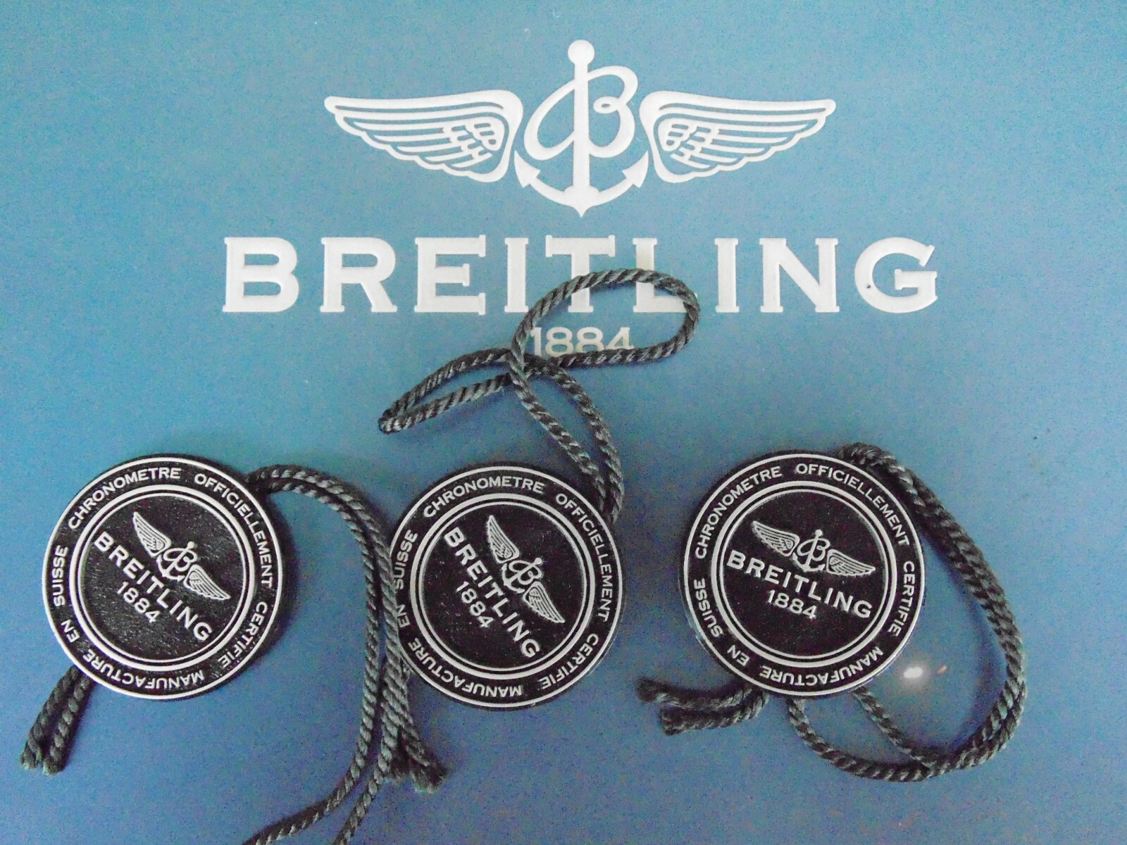 BREITLING FACTORY JEWELER’S BLACK PLASTIC WATCH HANG / SWING TAG THREE PIECE LOT