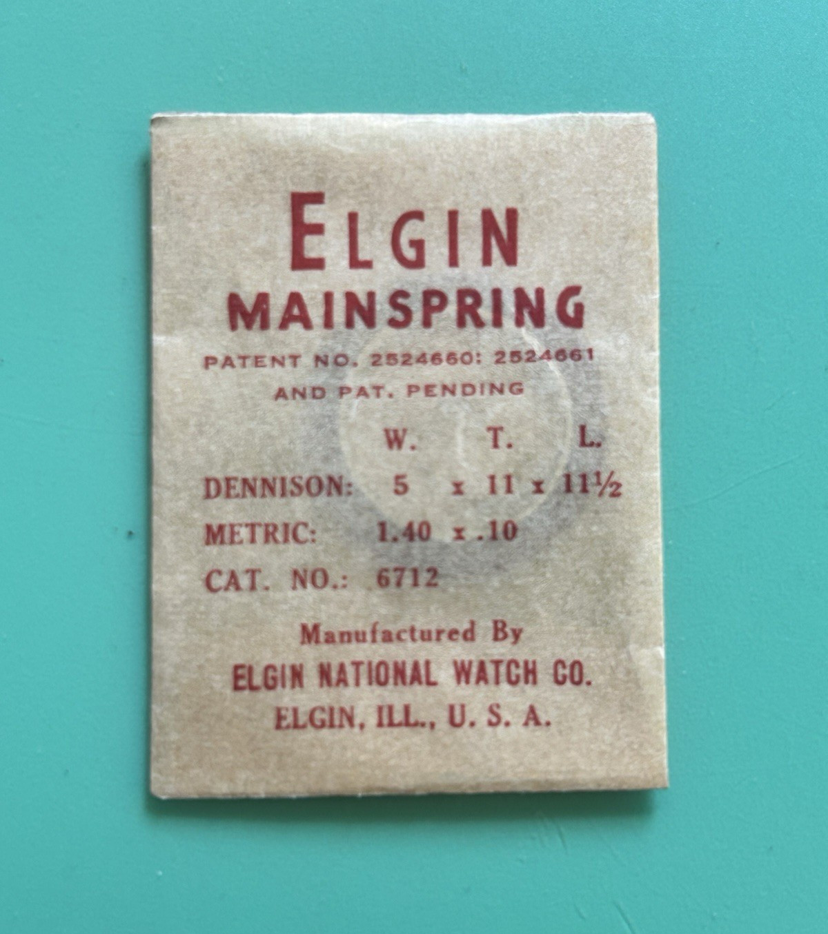 Elgin – 5/0 Cal. – Mainspring – Cat. 6712 – 5 wide x 11 tall x 11 1/2 long -NOS