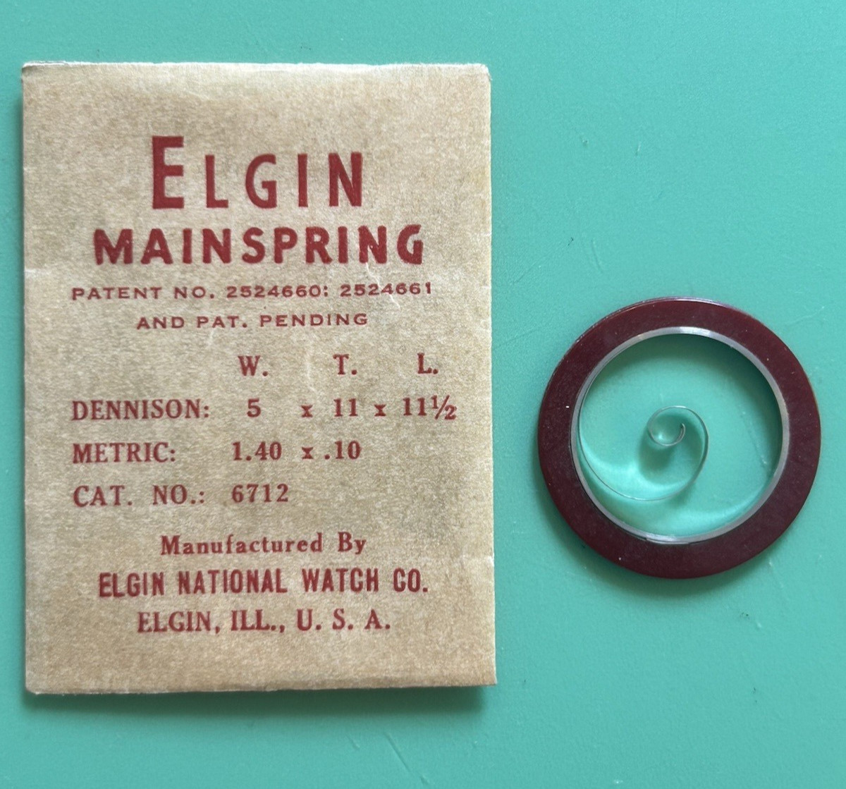 Elgin – 5/0 Cal. – Mainspring – Cat. 6712 – 5 wide x 11 tall x 11 1/2 long -NOS