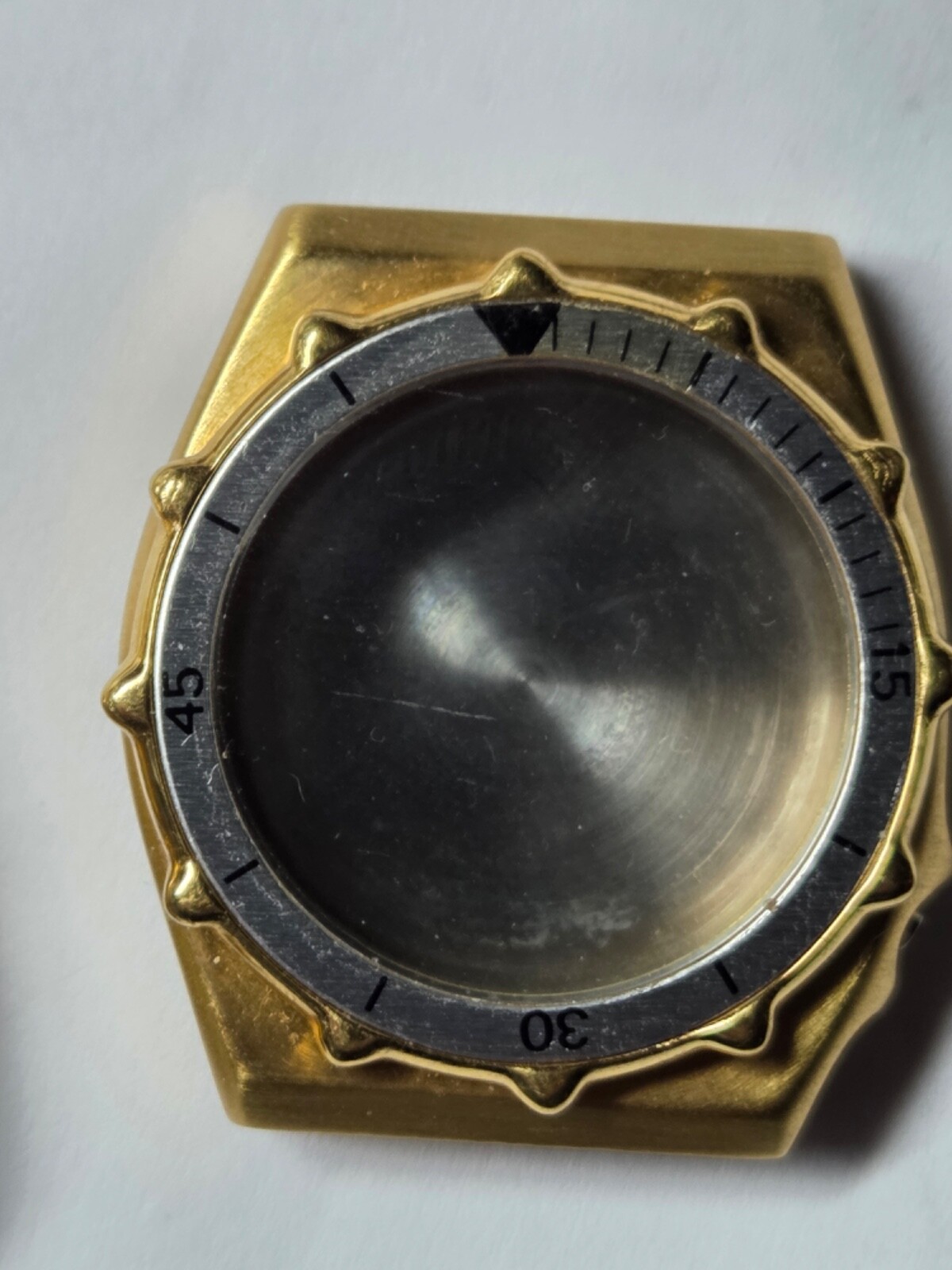 Four (4) men’s watch cases. 1980’s. For quartz movements. One has rotating bezel