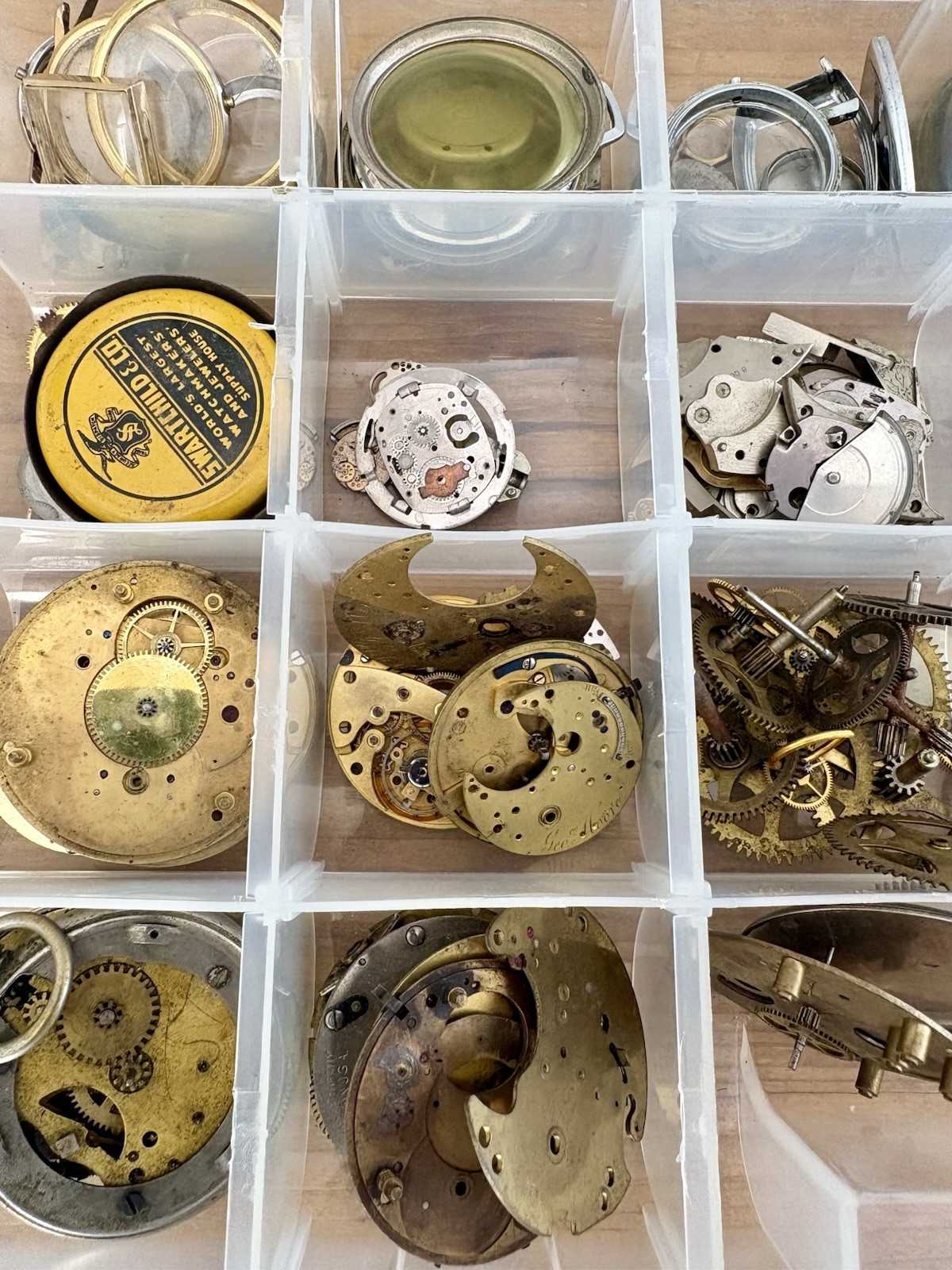 Watchmaker parts Lot w/ Box Movements Dials Gears Bulova Omega Benrus Elgin