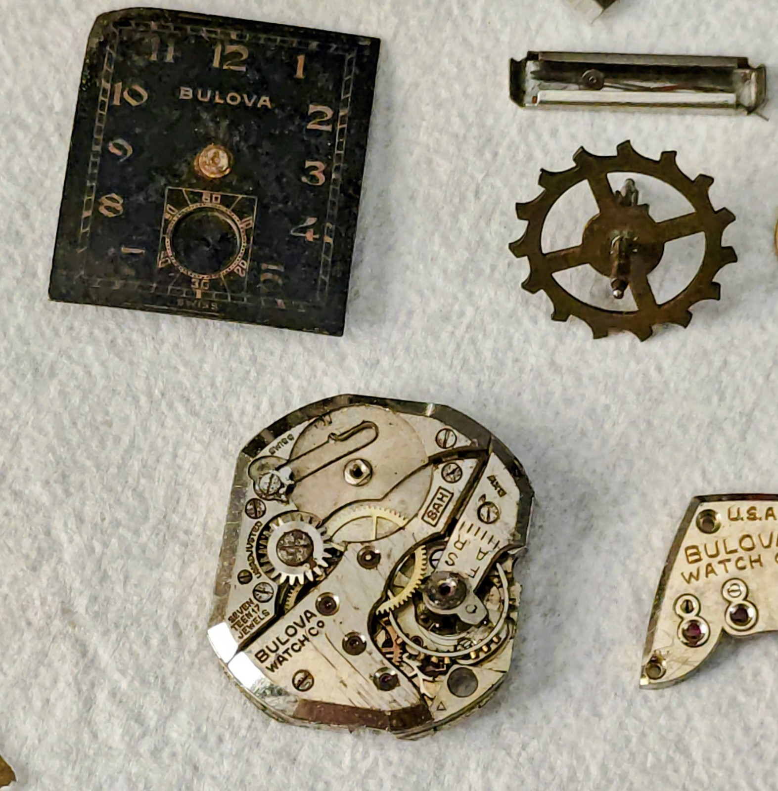 Vintage Watch Parts Including Bulova In A Small Metal Tin Can Approx 13 X 38mm