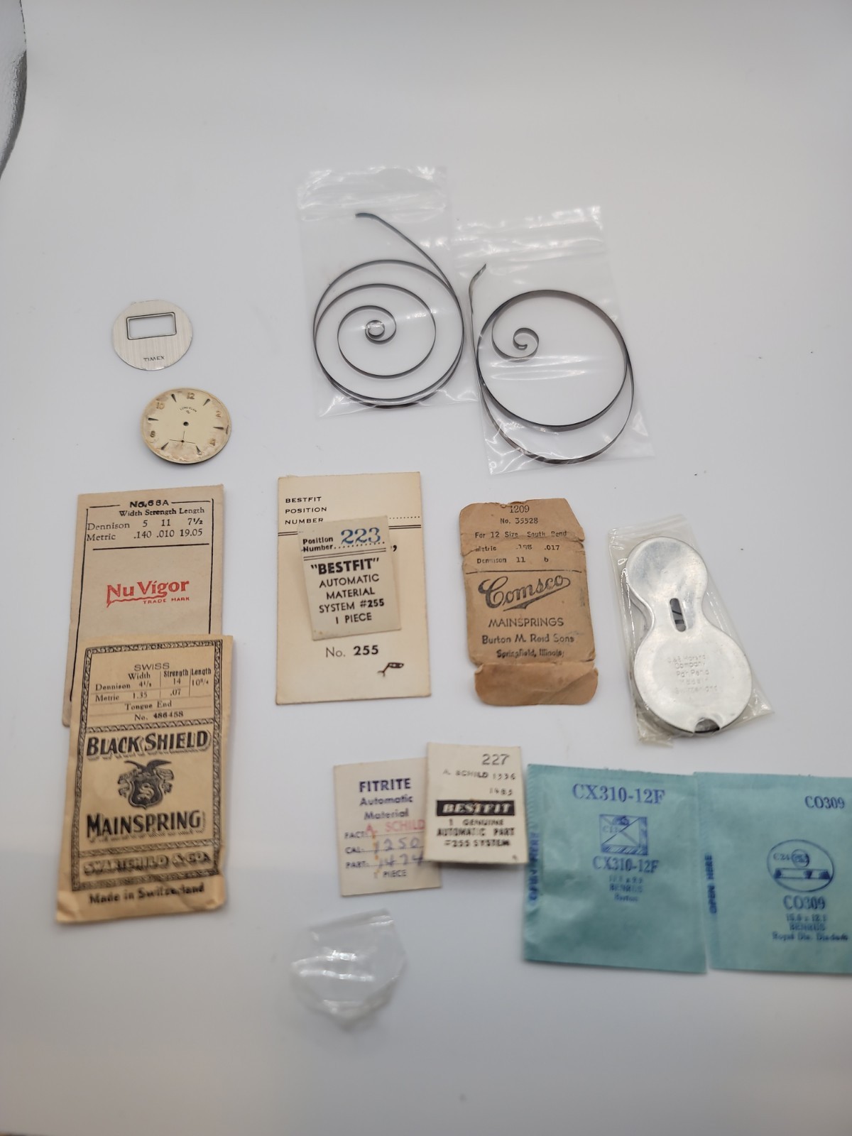 Lot of 12 Vintage Mainsprings, Crystals, Dials And More. Elgin Benrus Bulova