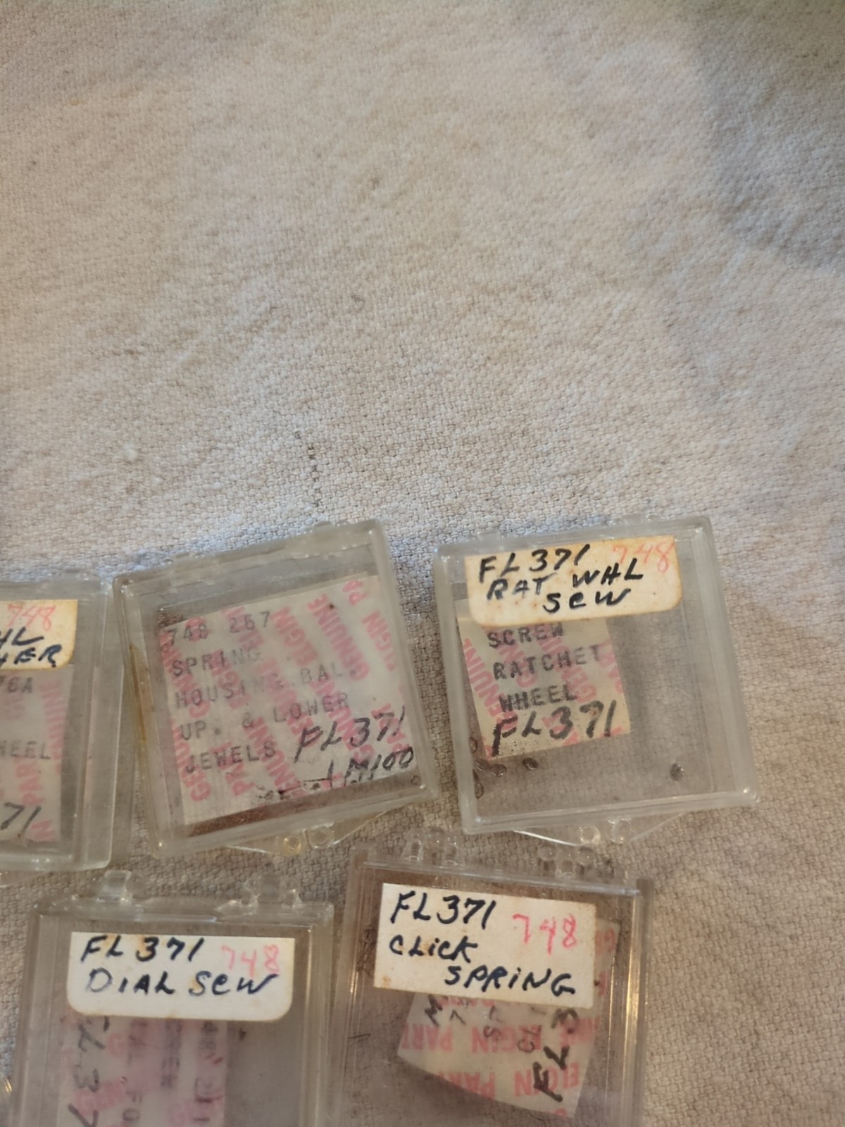 17 Boxes of Elgin 748 Movement Unused Jewels, Screws, Wheels, Regulators Etc…!