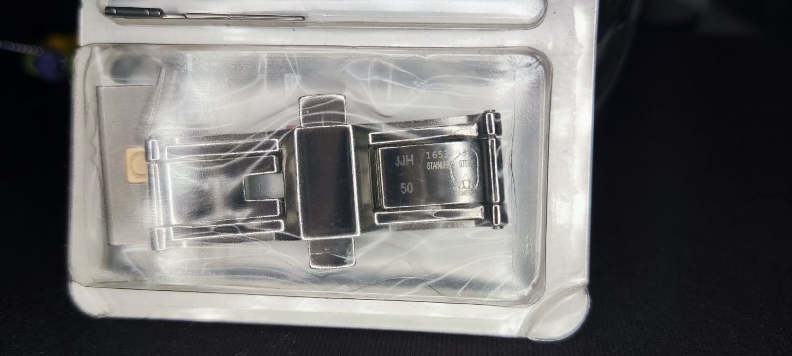 Omega steel clasp, with gold logo