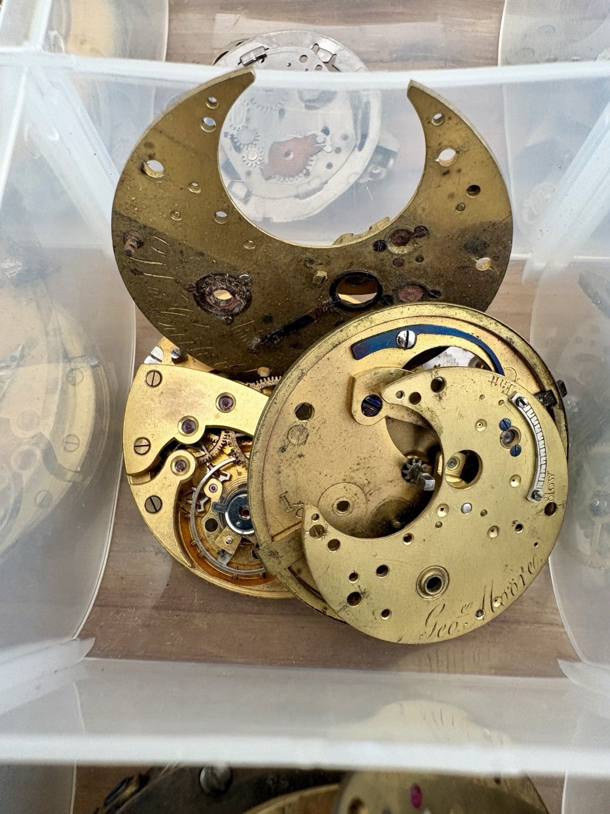 Watchmaker parts Lot w/ Box Movements Dials Gears Bulova Omega Benrus Elgin