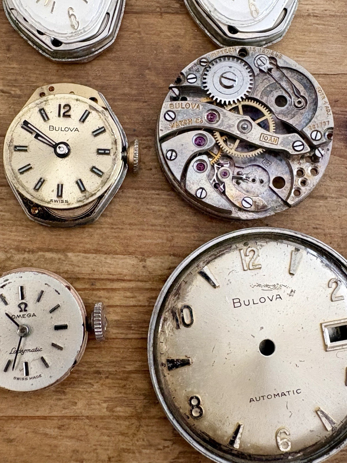 Watchmaker parts Lot w/ Box Movements Dials Gears Bulova Omega Benrus Elgin