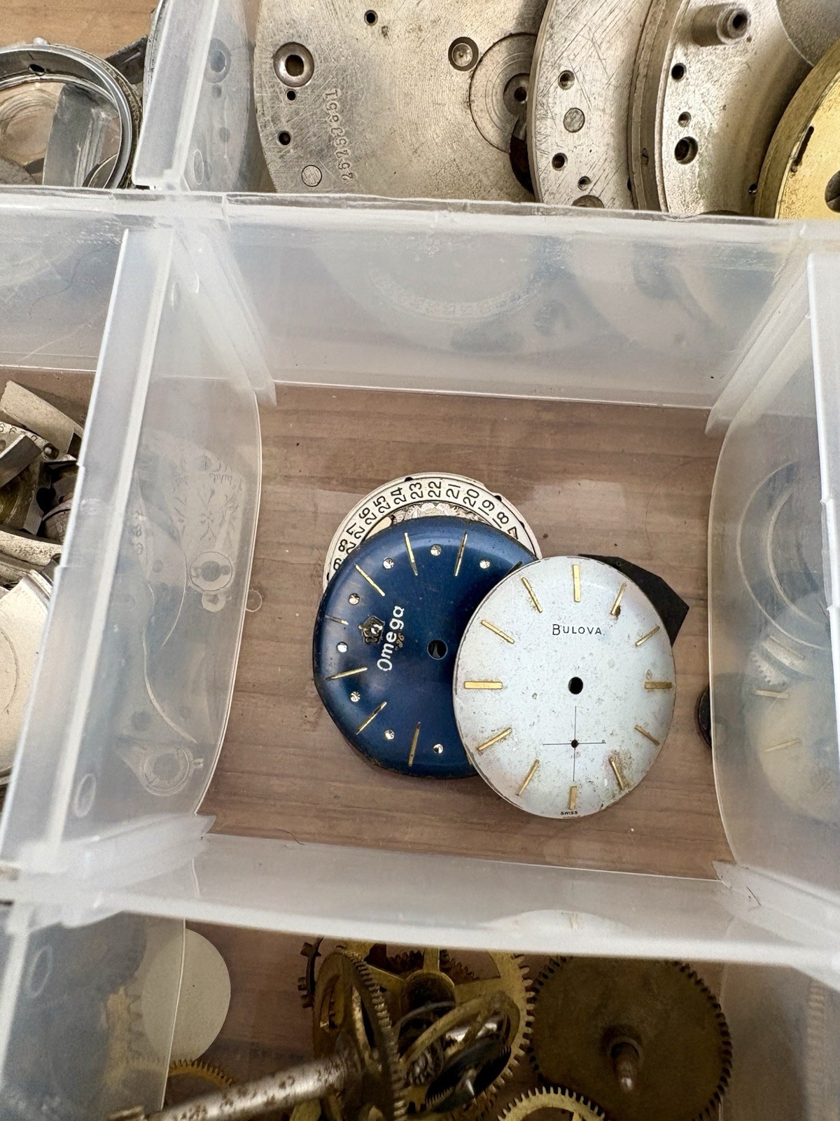 Watchmaker parts Lot w/ Box Movements Dials Gears Bulova Omega Benrus Elgin
