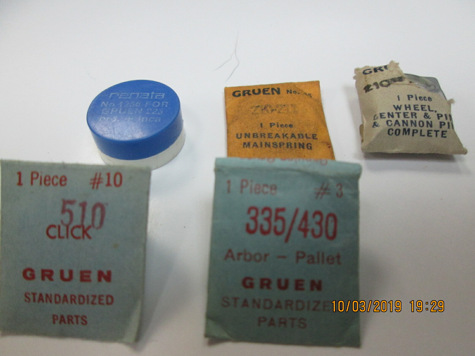 NOS GRUEN WATCH PARTS 5 PIECES STEMS, 1 BALANCE WHEEL AND HAIRSPRING, MAINSPRING
