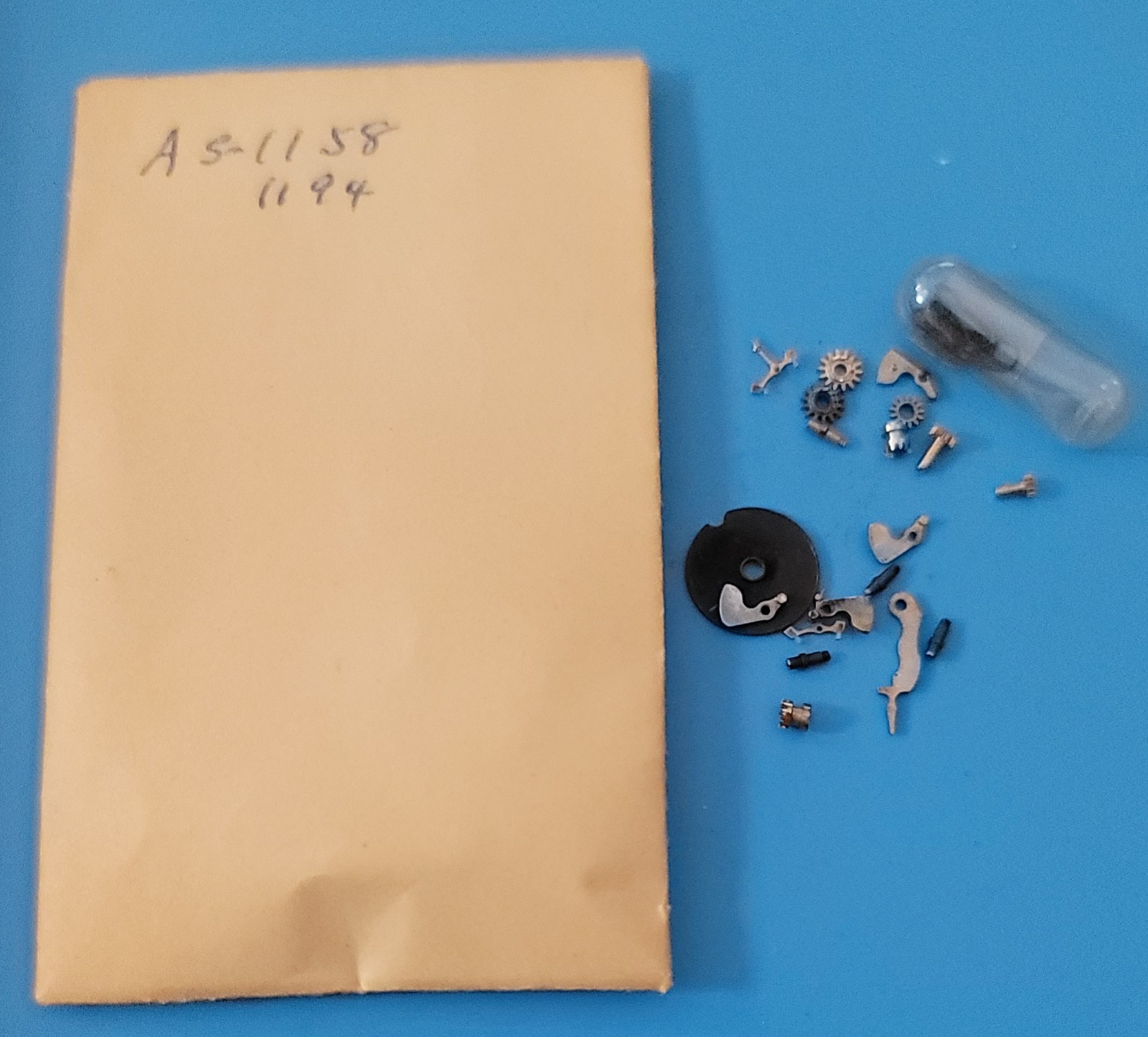 SB2-010: Lot of NOS Watch Parts AS 1187/1194 – Levers, Springs, Staffs, Gears