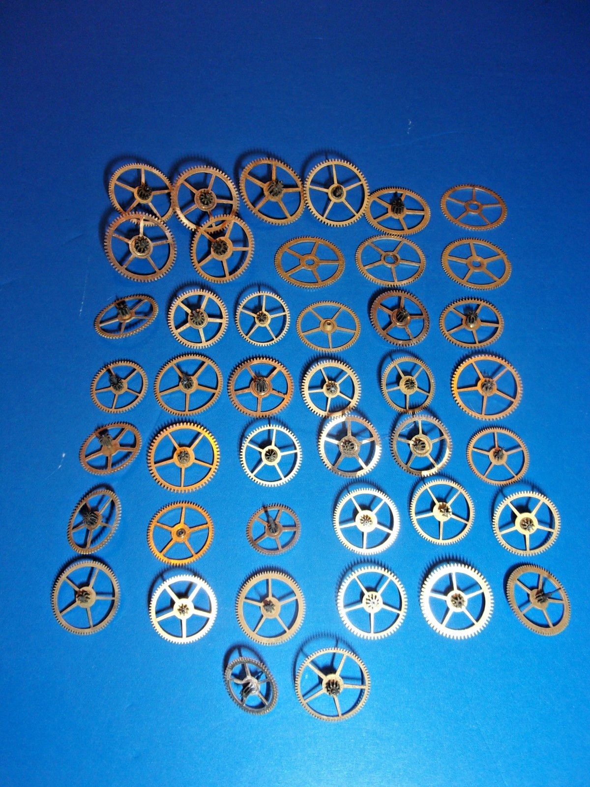 Elgin Pocket Watch Parts, Mix of 3rd and 4th and other power Train Gears + Tin
