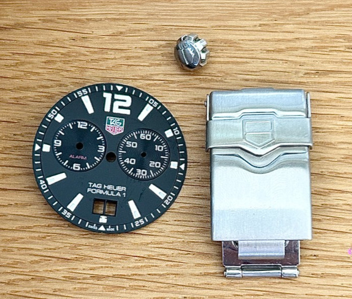 A Tag Heuer Formula 1 Wristwatch Dial, Crown and Bracelet Clasp.