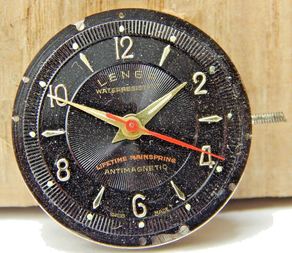Vintage Fewa QL Lengr men’s wrist watch movement with black dial hands and stem