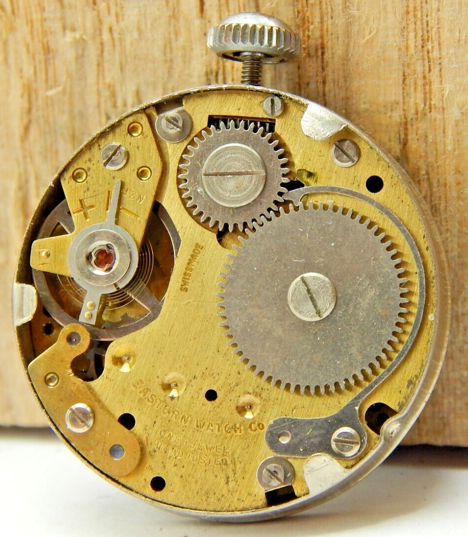 Vintage Eastern men’s wrist watch movement with black dial hands and crown combo