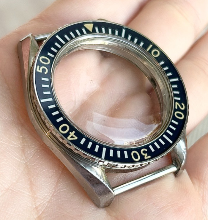 A rare Omega Seamaster 300 Military wristwatch case with blue bakelite bezel.