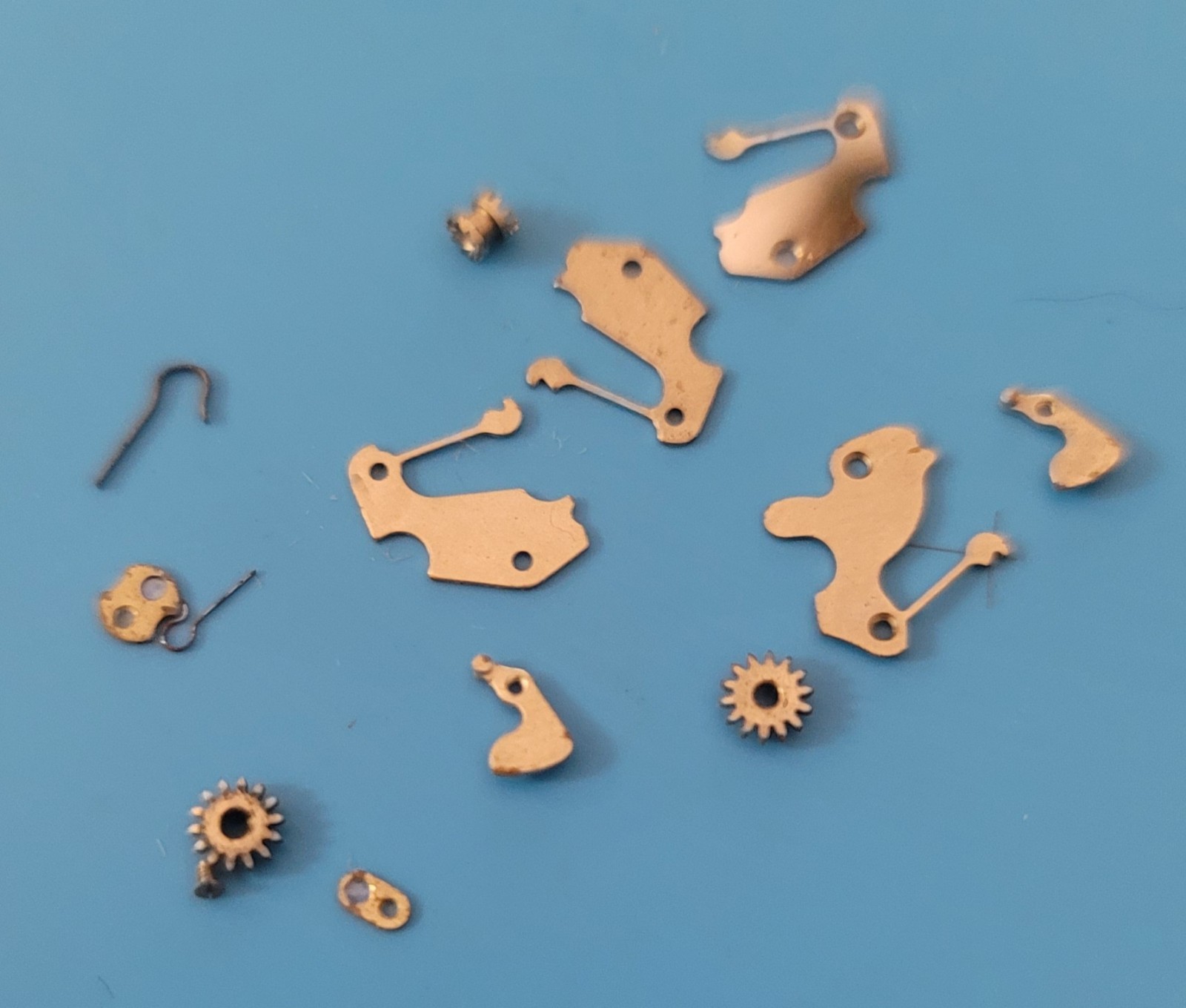 SB2-010: Lot of NOS Watch Parts AS 1187/1194 – Levers, Springs, Staffs, Gears