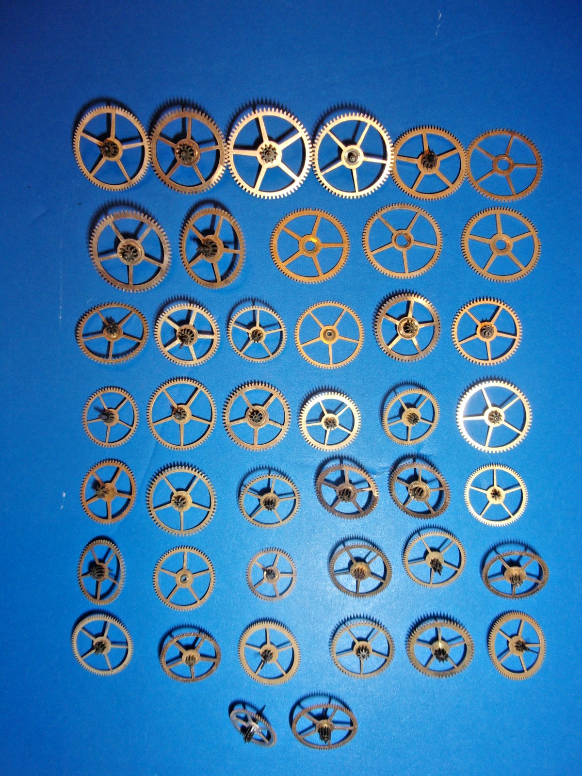 Elgin Pocket Watch Parts, Mix of 3rd and 4th and other power Train Gears + Tin