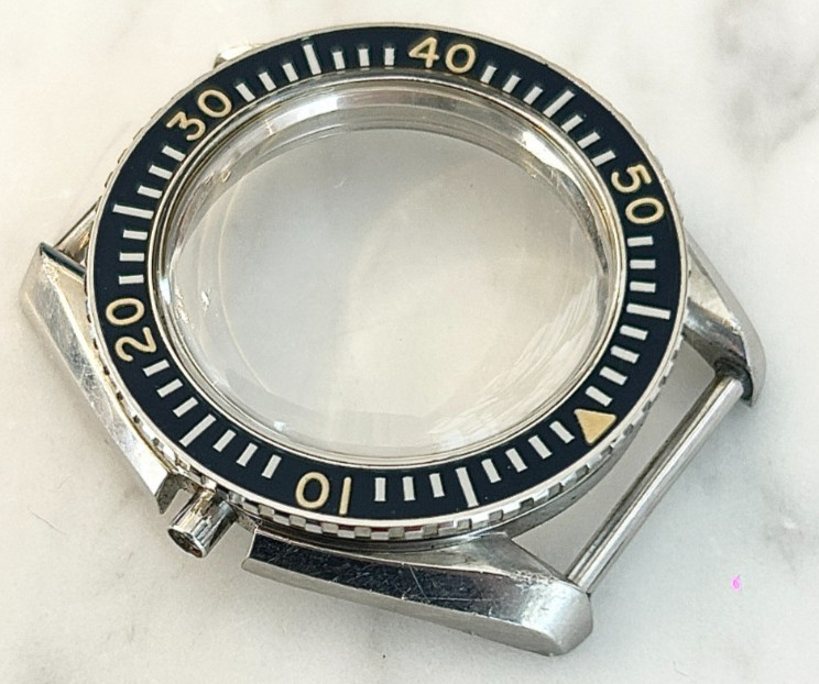 A rare Omega Seamaster 300 Military wristwatch case with blue bakelite bezel.