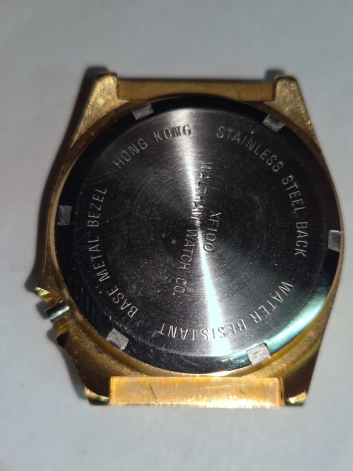 Four (4) men’s watch cases. 1980’s. For quartz movements. One has rotating bezel