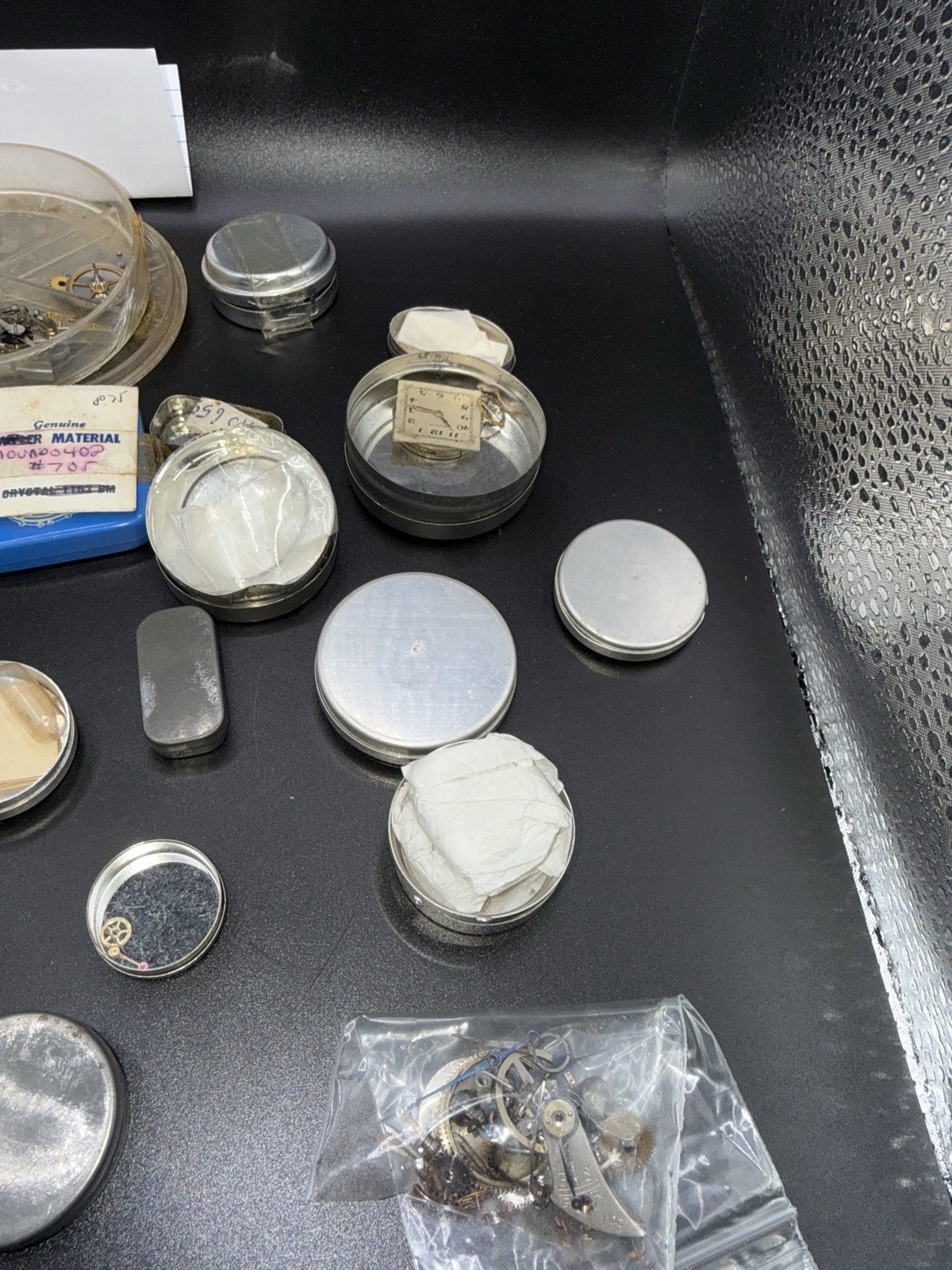 Lot 21 – Watchmaker Parts Lot Movements Staffs Tins Crystals Repair Mixed NOS