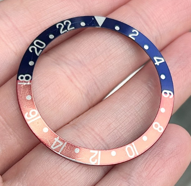 A Genuine Rolex “Pepsi” Blue & Red Bezel Insert for GMT Master Wristwatch.